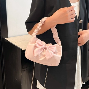 Chic pink handbag with silk bow and pleated handle on a silver chain shoulder strap