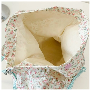 Top view of floral canvas tote bag showing interior lining and purple snap closure