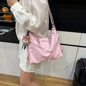 Pink glossy large tote bag worn by a model in a bright modern kitchen setting