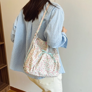 Floral canvas backpack for women with blue plaid bow and adjustable straps on white background