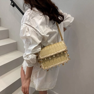 Sac bandoulière bohémien en paille avec breloques coquillages et dentelle blanche