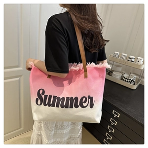Detail of pink gradient canvas tote bag with fringe edge and Summer text print