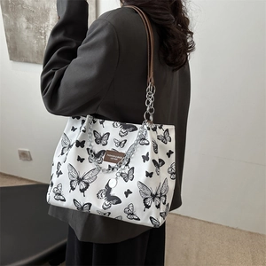 Large butterfly print canvas tote bag with chain strap and brown leather accents