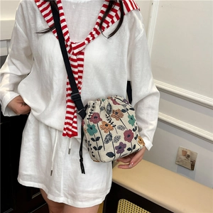 Floral embroidered drawstring bucket bag with adjustable black shoulder strap for summer