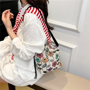 Chic drawstring bucket bag with colorful vintage floral jacquard and black thin strap