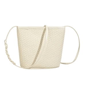 Minimalist white bucket bag with woven texture and braided shoulder strap details