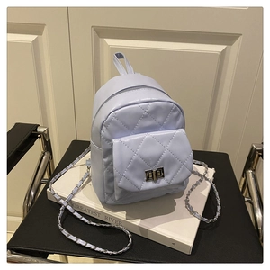 Detail of light blue quilted mini backpack with silver twist lock and chain strap