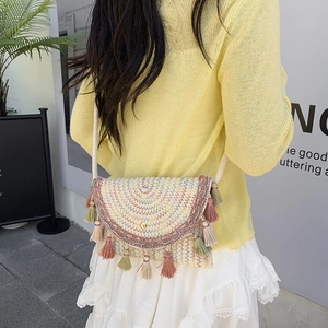 Bohemian woven saddle bag with colorful tassels and geometric patterns for summer vacations