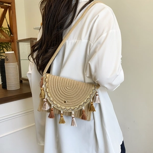 Woven saddle bag with multi-color tassels and braided shoulder strap for summer vacation