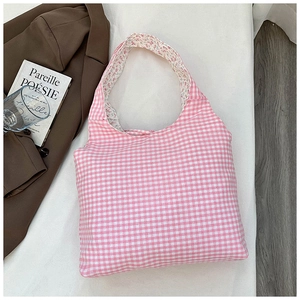 Detail of gingham tote bag with floral lining on an aesthetic lifestyle background