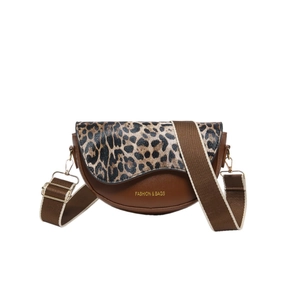 Vintage brown leather saddle bag with leopard print flap and wide textile strap