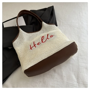 Detail of knitted tote bag with Hello embroidery and premium brown leather base