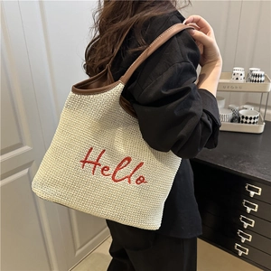 Straw woven shoulder bag with red Hello embroidery and brown leather straps for women
