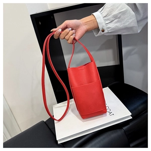 Detailed macro view of the red lychee pattern leather mobile phone crossbody bag