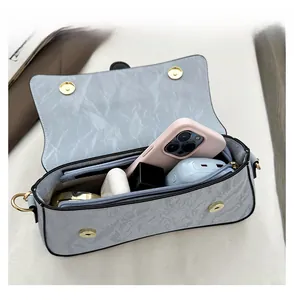 Detail display of marble pattern crossbody bag showing spacious inner storage capacity