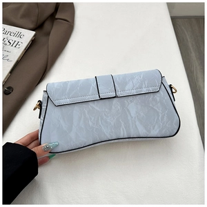Detail of light blue wrinkled texture leather shoulder bag with chic belt buckle