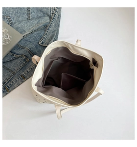Spacious interior of white tote bag featuring grey fabric lining and inner side pocket