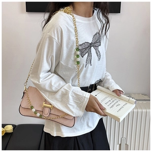 Chic pink shoulder bag with gold chain strap and decorative green and pearl beads
