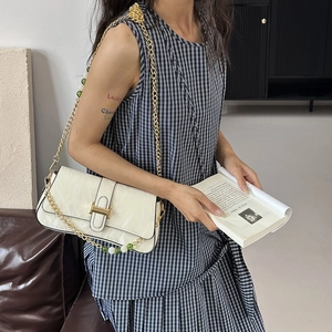 French vintage white shoulder bag with gold chain strap and buckle shown on model