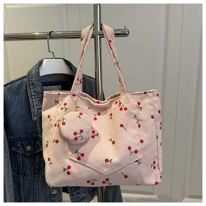 Pink corduroy tote bag with cherry print, front pocket and matching round coin purse