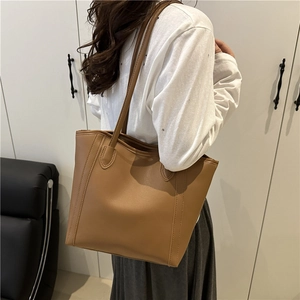 Minimalist brown leather tote bag with double shoulder straps and vertical stitching detail