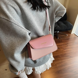 Pink minimalist crossbody bag with woven texture and adjustable strap for women