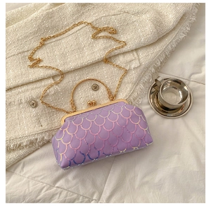 Detailed view of purple sequin evening bag with gold metal frame and chain strap
