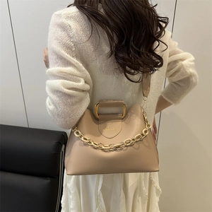 Elegant apricot shoulder bag with a square gold metal handle and resin chain detail