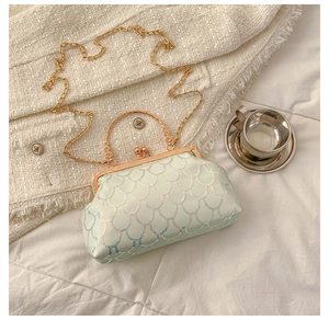 Detail of vintage evening bag with iridescent scale sequins and gold metal frame