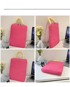 Detailed view of pink quilted floral laptop sleeve with yellow handles and dual zippers