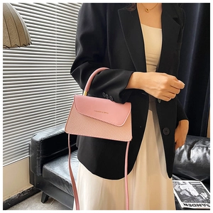 Detail of light pink crossbody bag with woven texture and gold Fashion & Bags lettering
