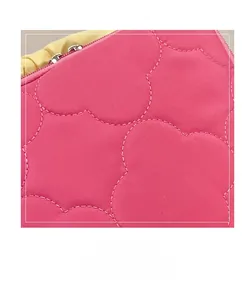 Detail of quilted rose pink laptop sleeve showing high-quality fabric and metal zipper