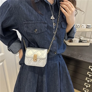 Silver quilted mini chain bag with gold CD buckle worn by a model in denim outfit
