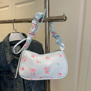 Floral print light blue shoulder bag with ruffled strap and pink rose patterns