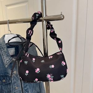 Detail of floral shoulder bag with pink roses and scrunchie handle on hanger