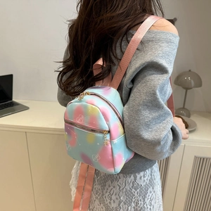 Mini gradient leather backpack with heart print shown from a side-rear angle on a model