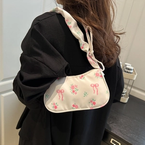 Floral print shoulder bag with pink roses and ribbon patterns on cream fabric