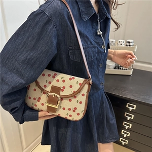 Stylish cherry print canvas shoulder bag with brown leather trim and golden buckle