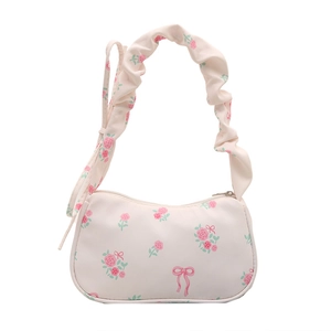 Floral shoulder bag with pleated handle featuring pink roses and red bows on cream canvas