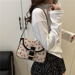 Chic cream canvas underarm bag featuring sweet red cherry prints and golden buckle