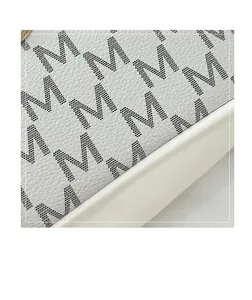 Detailed macro view of white lychee pattern leather with black dotted M letter print