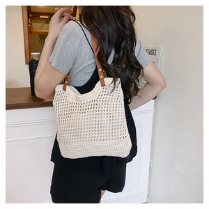 Dettaglio della borsa tote in maglia traforata con tracolla in pelle e rivetti
