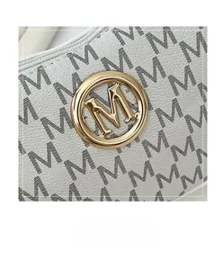 Close-up of pebble leather texture and golden metal logo on the white crescent bag
