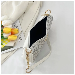 Detailed top view of white crescent bag with golden zipper and grey monogram prints