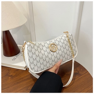 Detail view of white moon bag featuring grey M pattern and gold logo hardware detail