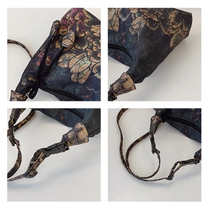 Detail view of crescent bag featuring vintage floral patterns and adjustable strap buckle