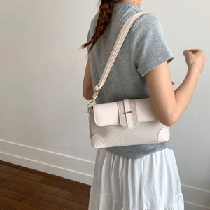 Chic beige textured fabric underarm bag with leather strap shown on model for daily use