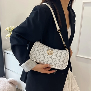 Fashionable beige crescent underarm bag with M-letter monogram and gold chain strap