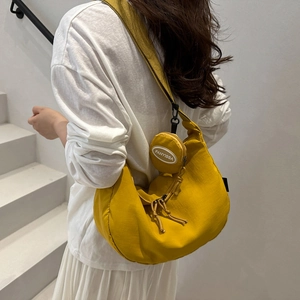 Bright yellow nylon hobo shoulder bag with a round coin purse and wide strap