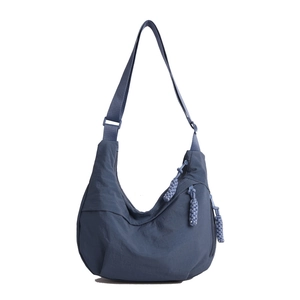 Navy blue nylon crossbody hobo bag with braided zip pulls and adjustable strap